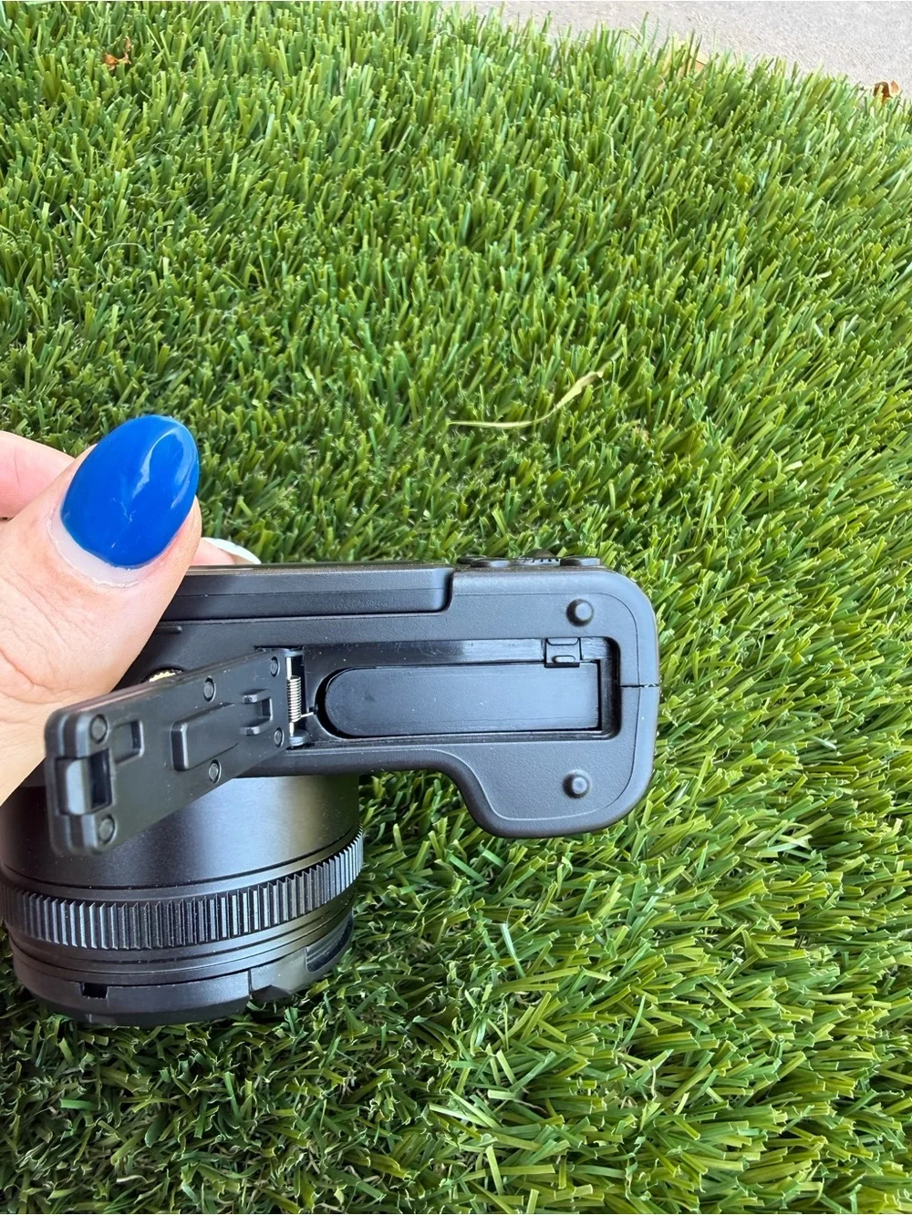 Compact Black Digital Camera with Accessories and Lens Cap